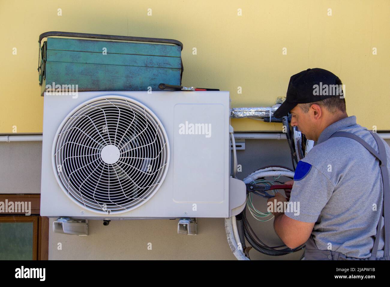 Photo of a plumber assembling and servicing the engine of a home air