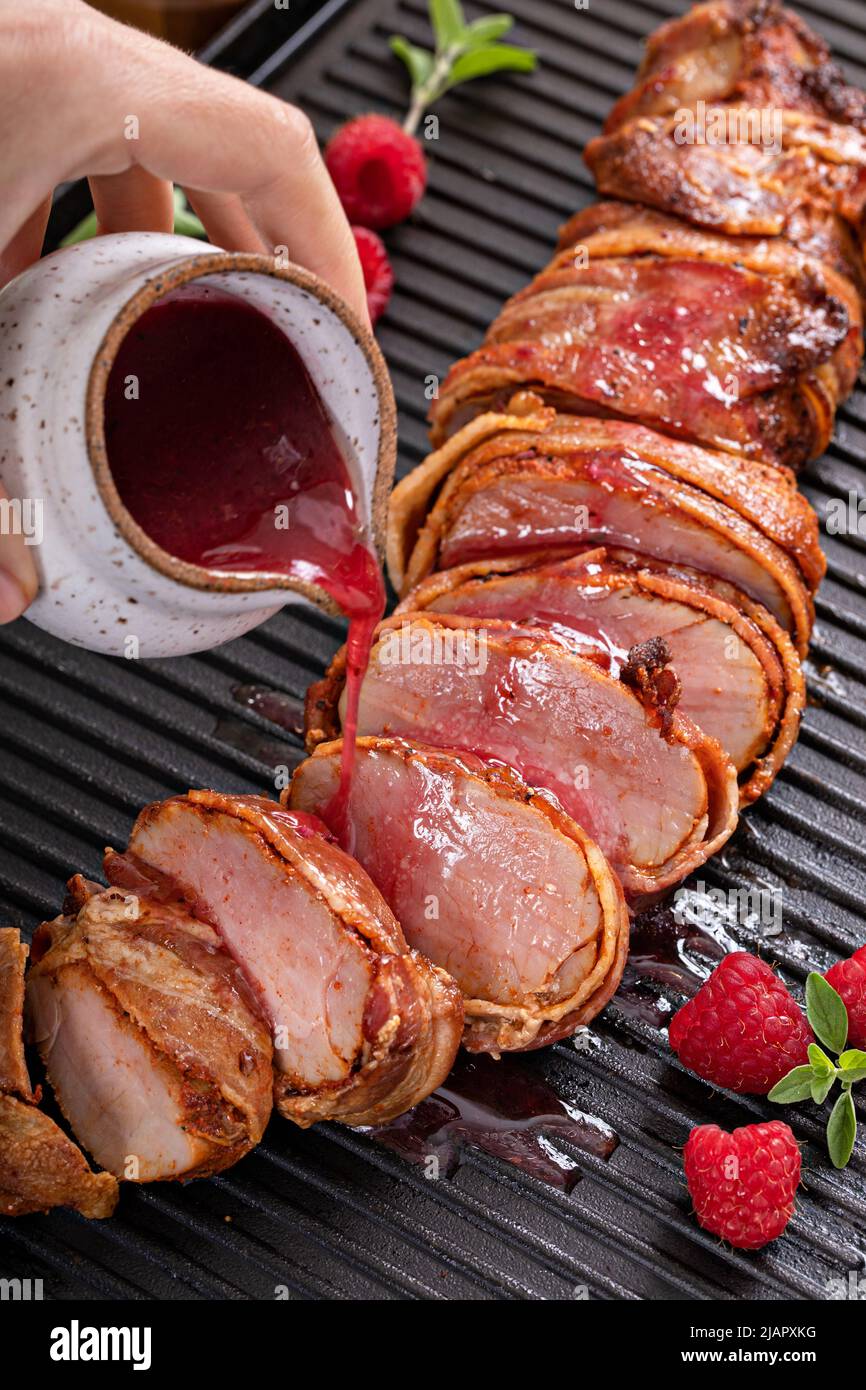 Bacon wrapped pork tenderloin with raspberry vinaigrette Stock Photo