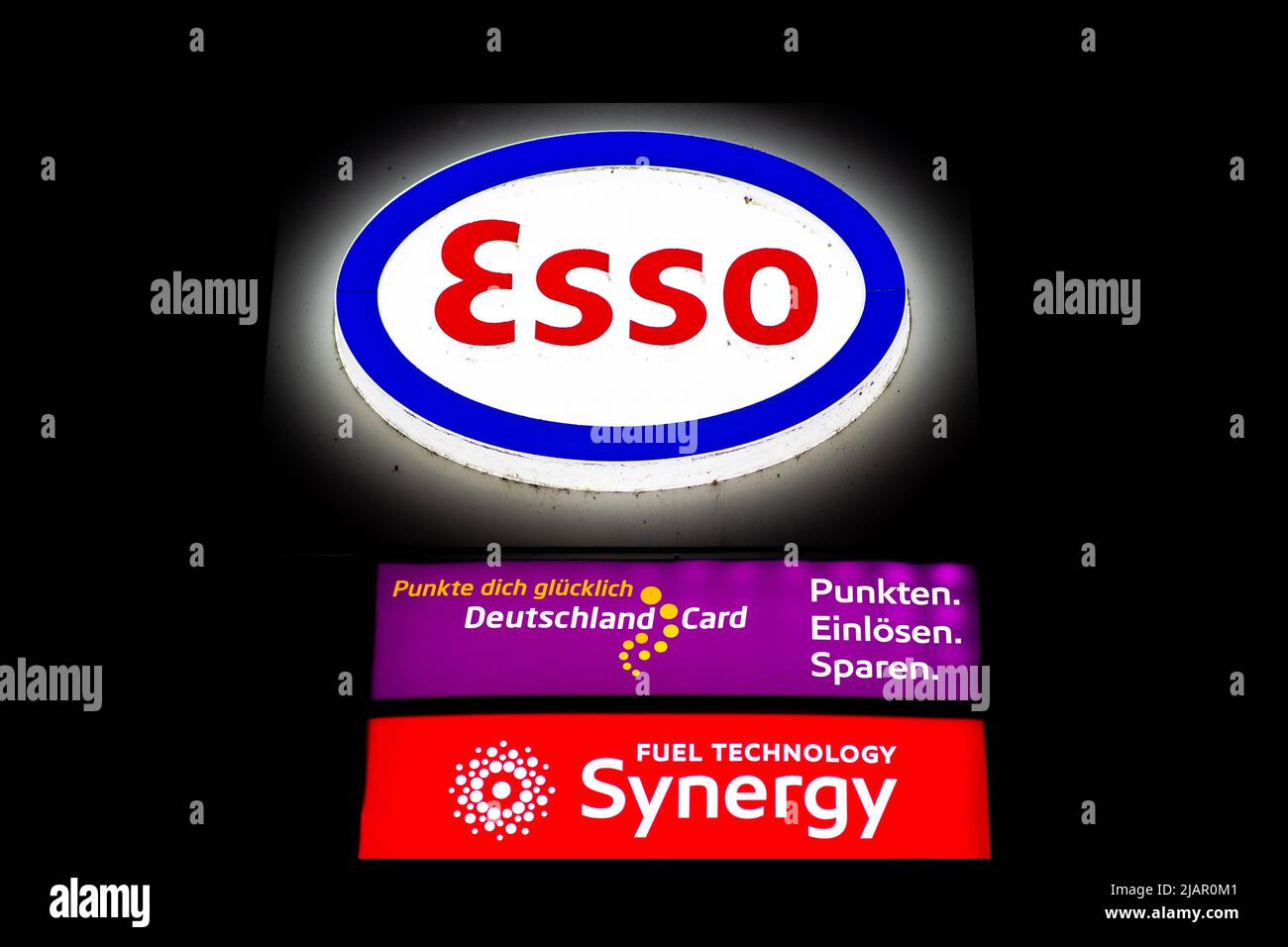 Oldenburg, Germany. 01st June, 2022. The Esso logo lights up at a gas station shortly before midnight. The tax burden on fuels will fall by 35.2 cents per liter for premium gasoline and by 16.7 cents per liter for diesel from Wednesday until the end of August. Credit: Hauke-Christian Dittrich/dpa/Alamy Live News Stock Photo