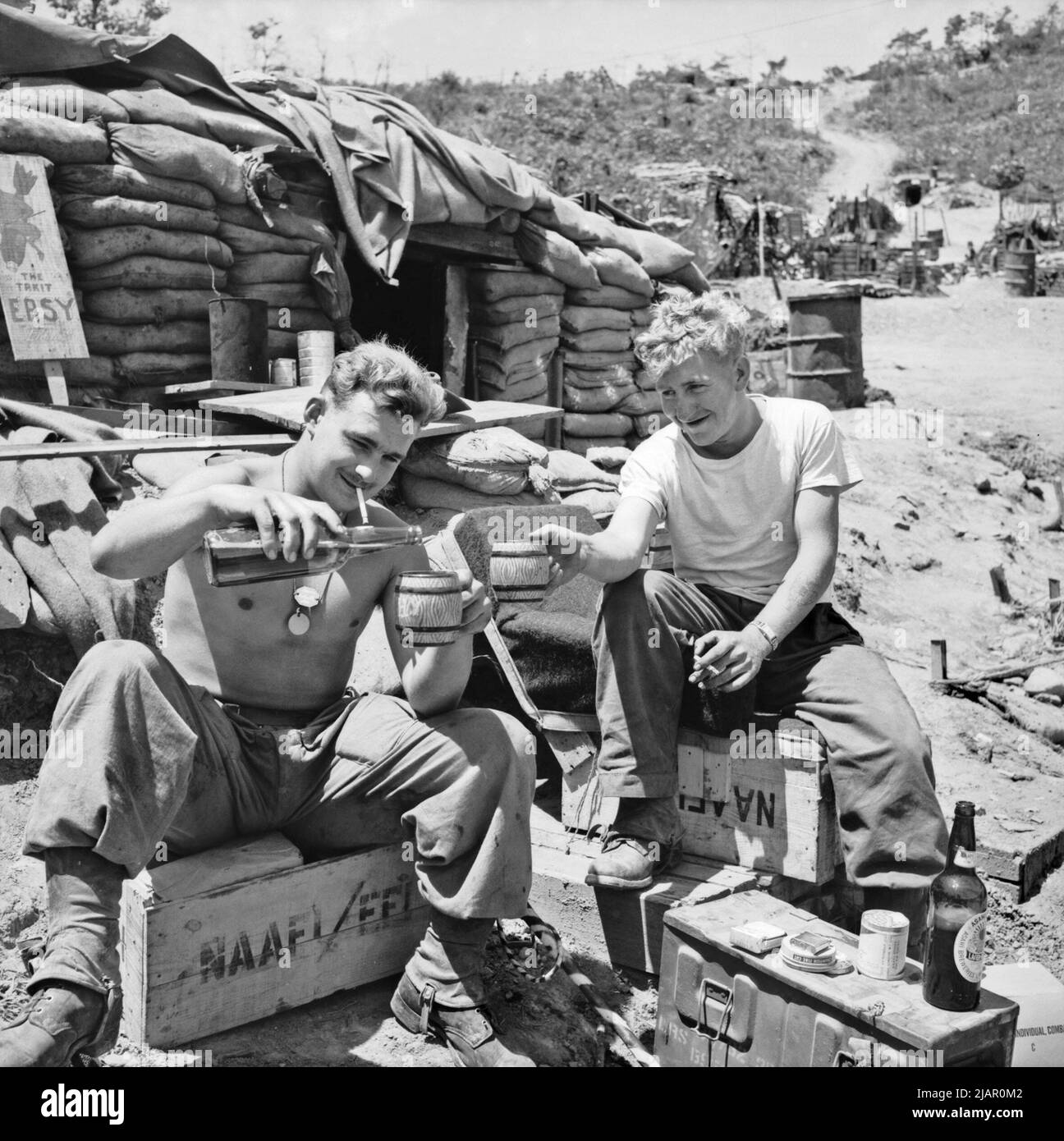 Two unidentified Australian soldiers enjoy some recreation time at a sandbagged Navy Army Air Force Institute (NAAFI) in Korea ca. 1952 Stock Photo