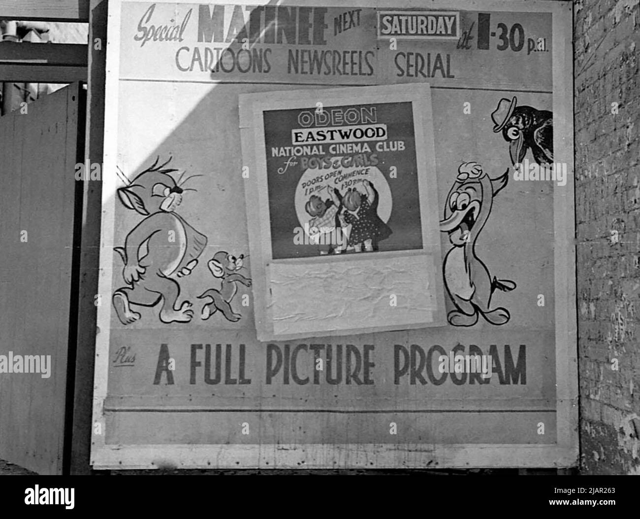 Poster outside of a movie theater advertising cartoons, news reels and serials for children, Eastwood Odeon in Eastwood N.S.W. ca. 1947 Stock Photo