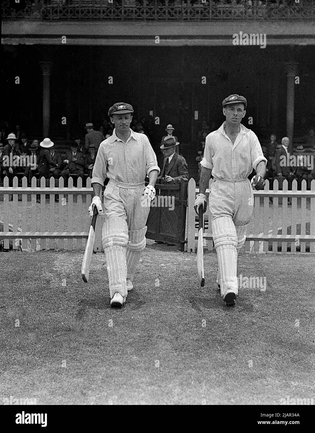 Two cricket players walking onto a field in Sydney ca. 1936 Stock Photo