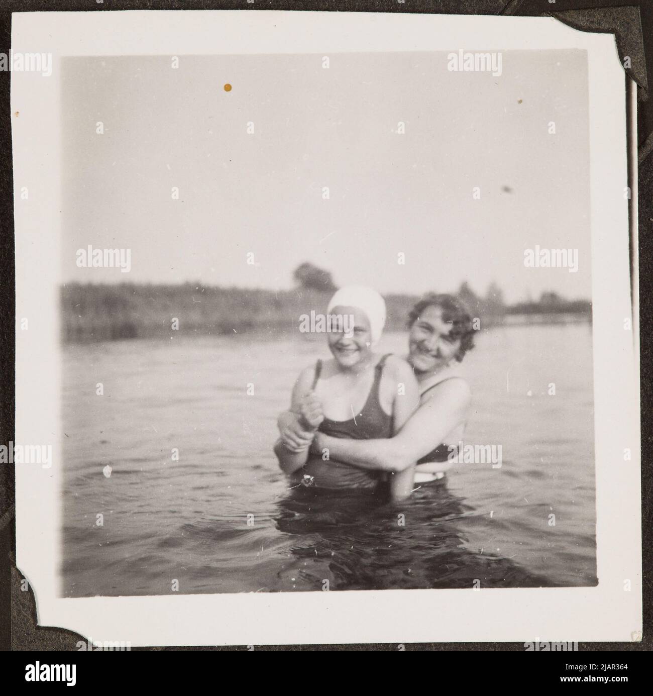 Two young women in swimsuits immersed in half the characters in the