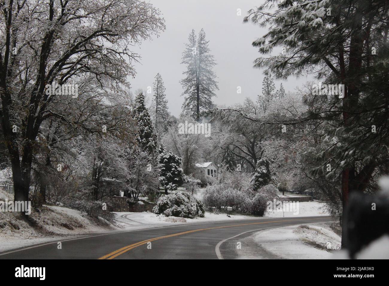 cabin in snowy mountains with a frozen road Stock Photo - Alamy