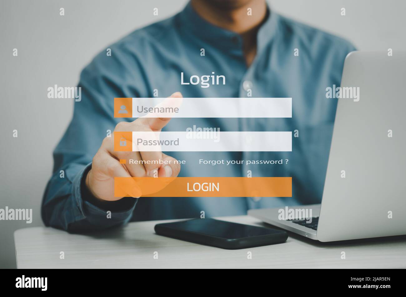 man using laptop computer and sign up or log in username password virtual touch screen. Stock Photo