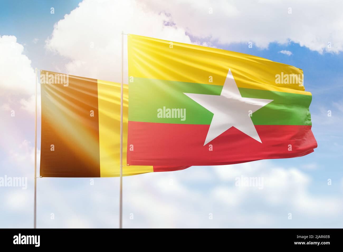 Sunny blue sky and flags of myanmar and belgium Stock Photo - Alamy