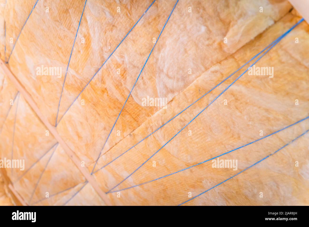 Hemming roof insulation with polypropylene thread Stock Photo - Alamy