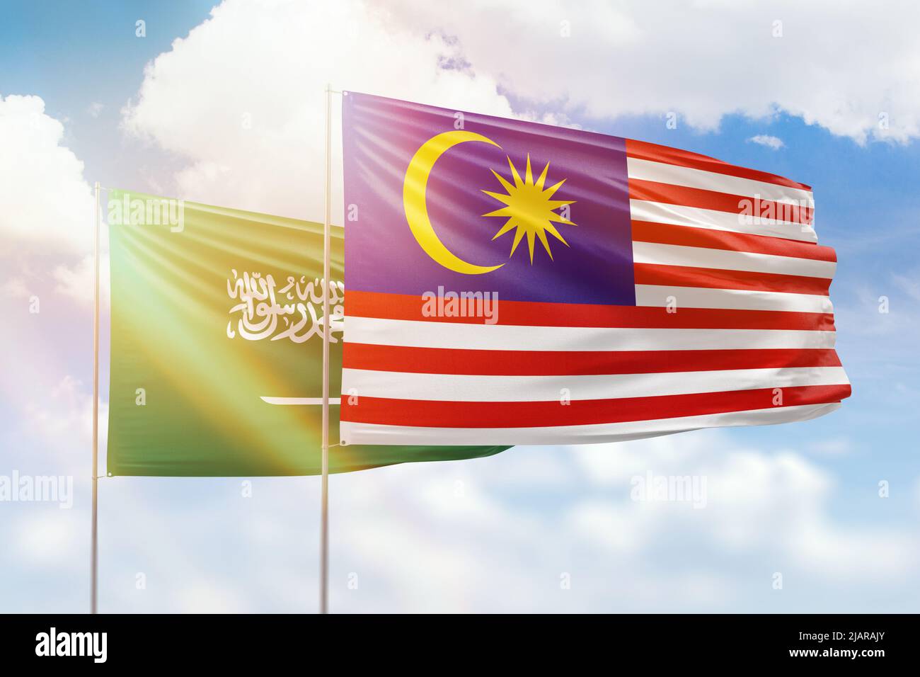 Sunny blue sky and flags of malaysia and saudi arabia Stock Photo