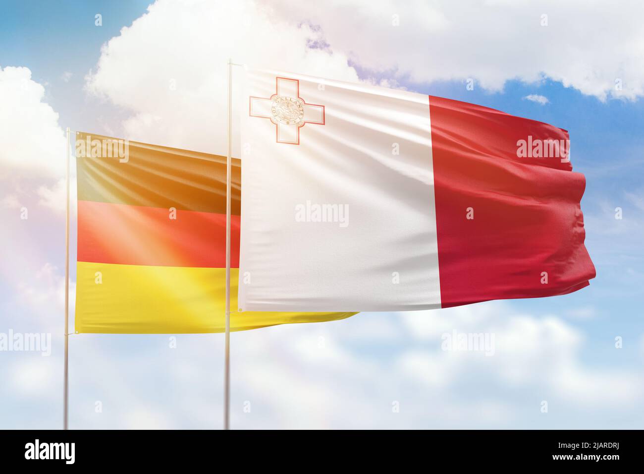 Sunny blue sky and flags of malta and germany Stock Photo Alamy