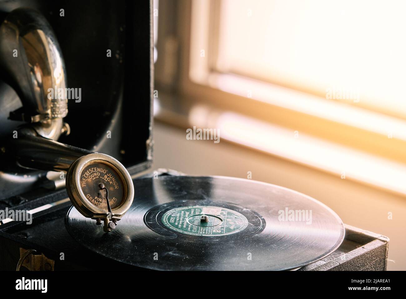 antique portable gramophone with a powder covered vinyl record Stock Photo