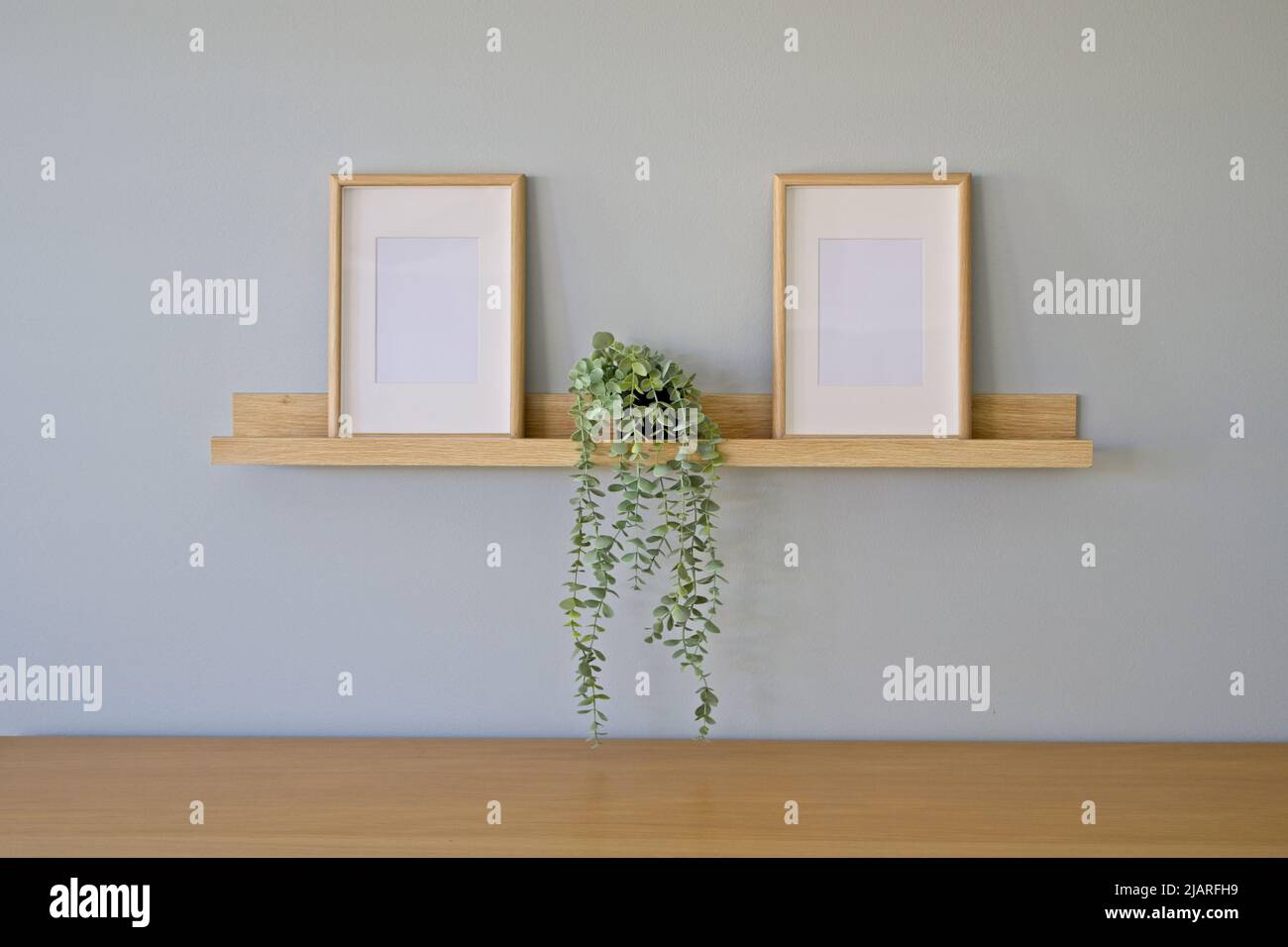Interior frame mockup with empty frame on a wooden shelf Stock Photo