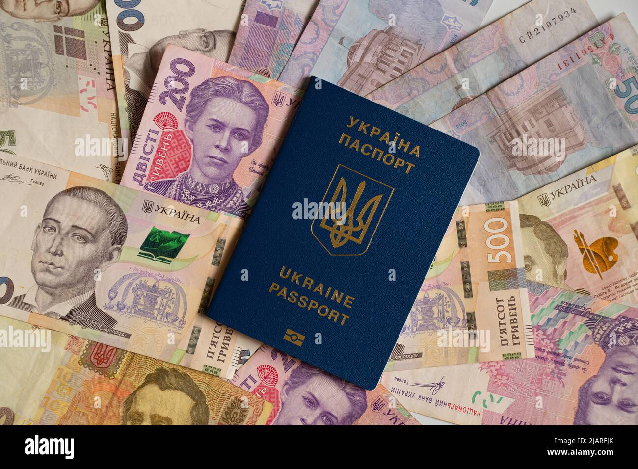 Biometric passport lies on Ukrainian money, the economy in Ukraine Stock Photo