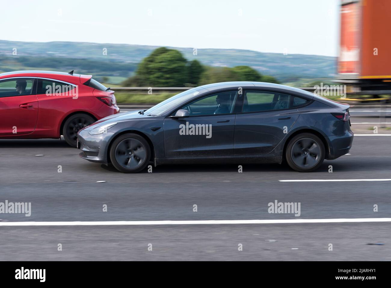 Electric Car (Tesla) on the M62 (near Huddersfield, England Stock Photo