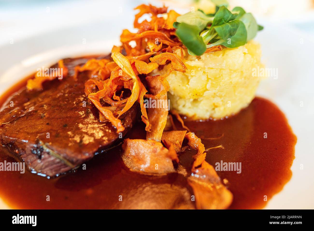 Meat in tomato and wine sauce with potatoes. Meat beef stewed in Burgundy wine Boeuf Bourguignon, Burgundy meat with mashed potatoes Stock Photo