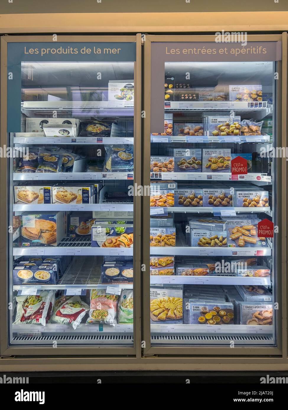Paris, France - April 6, 2022: Variety of frozen food at supermarket refrigerator. Sea food products in french language 'Les Produits De La Mer' Stock Photo