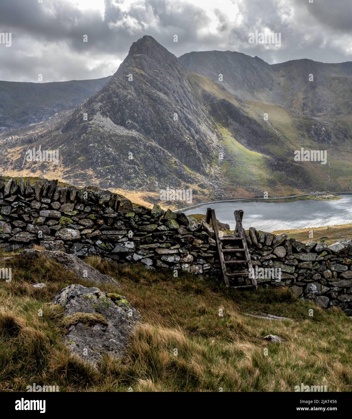 Snowdonia Landscape with Dry Stone Wall and Stile, Lake Ogwen and Tryfan Stock Photo