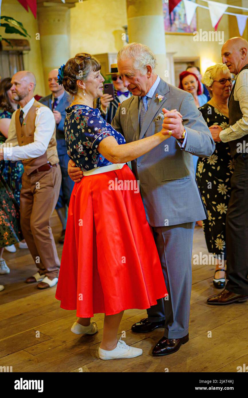 The Prince of Wales dances with Bridget Tibbs during a Jubilee tea