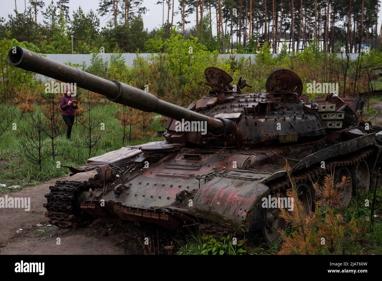 Dmytrivka, Ukraine. 31st May, 2022. A woman looks at destroyed Russian