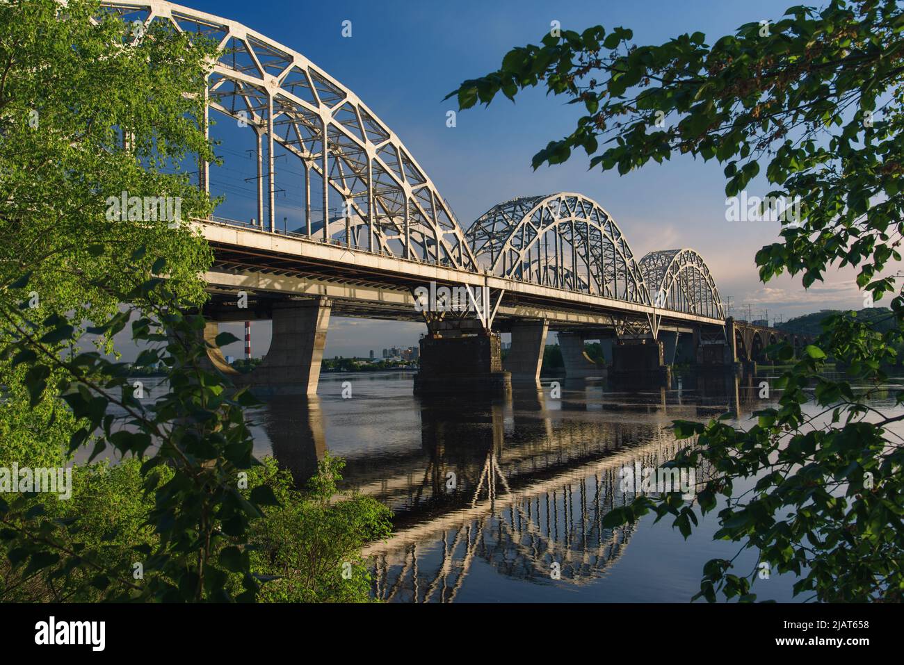 New Darnytskyi Bridge across Dnipro river in Kyiv, Ukraine on calm spring day Stock Photo