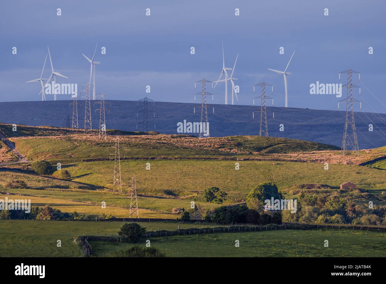 Wind farm and electricity pylons in Bury countryside. Stock Photo