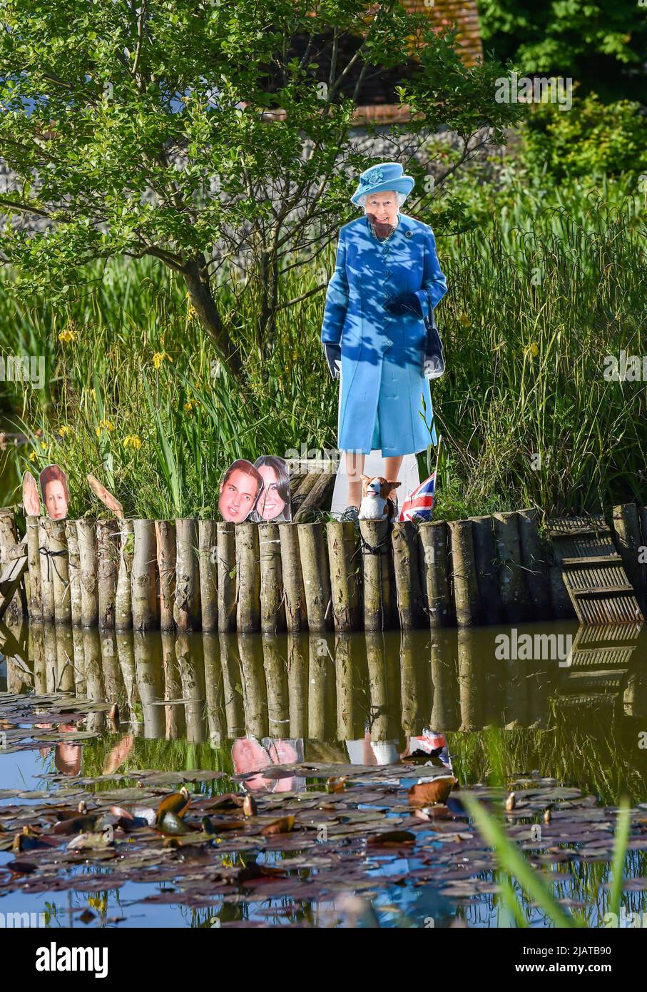 Brighton UK 1st June 2022 - Cardboard cutouts of The Queen and members of the Royal family have appeared on the duck pond in Rottingdean village near Brighton as they prepare for the Queen's Platinum Jubilee Celebrations over the next few days : Credit Simon Dack / Alamy Live News Stock Photo