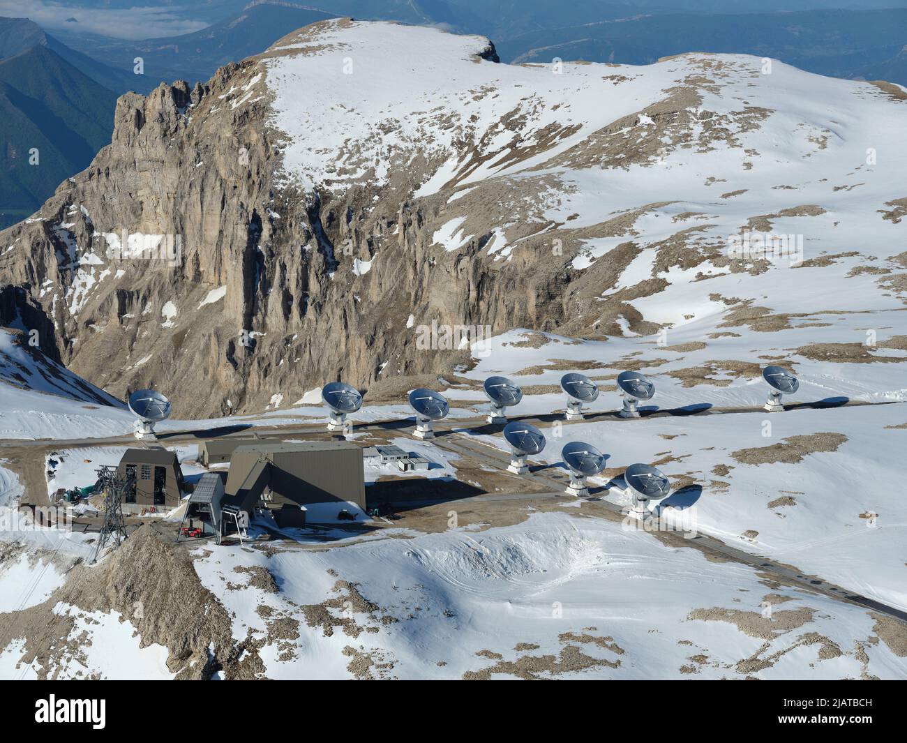 AERIAL VIEW. The Interferometer of the Bure Plateau wint the snow of May. Hautes-Alpes, France. Stock Photo