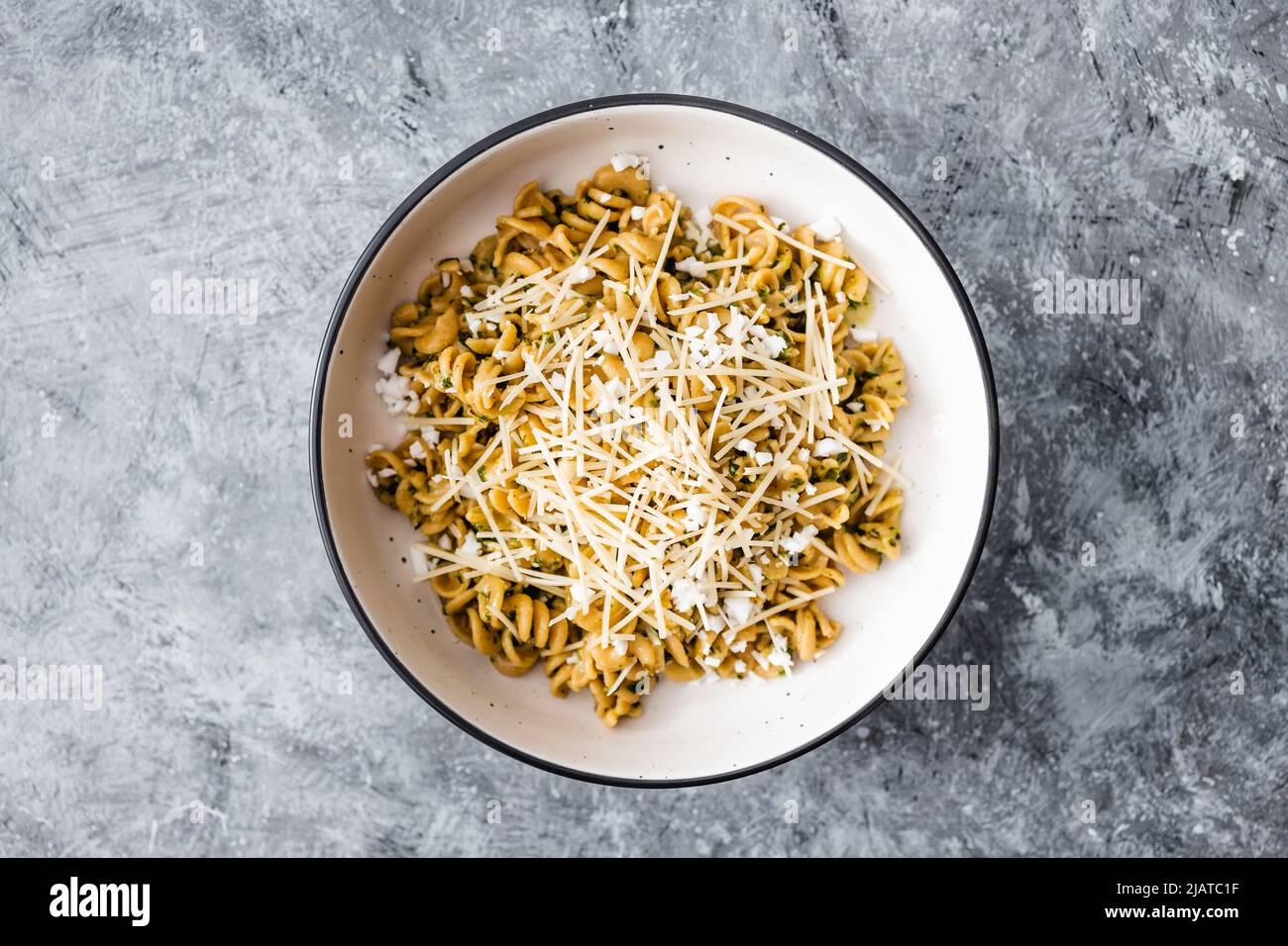 vegan spinach and dairyfree cheese pasta bowl with wholemeal spirals