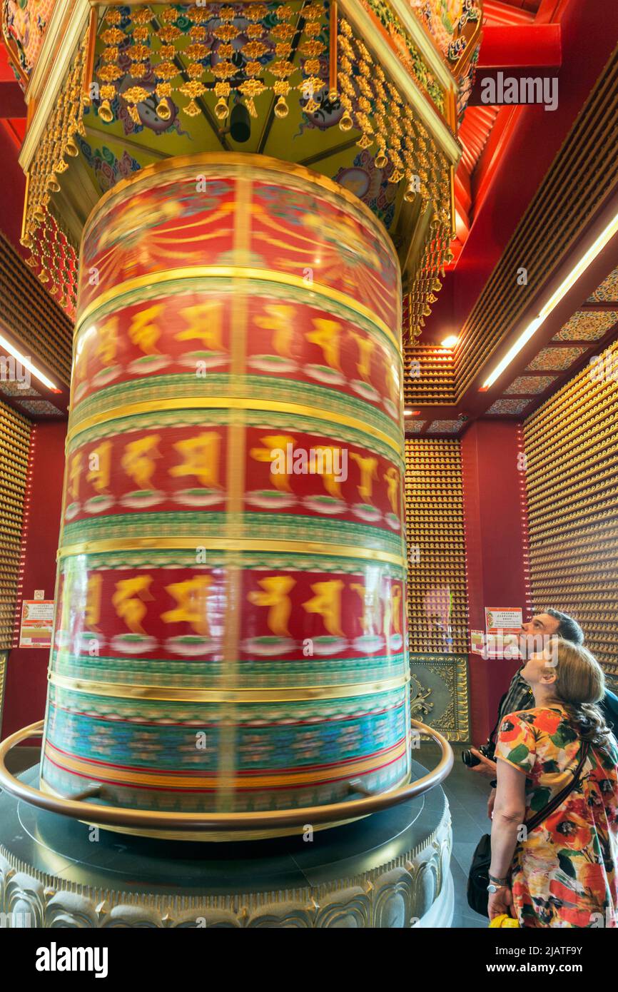 Prayer wheel in movement, Buddha Tooth Relic Temple and Museum Republic of Singapore. Stock Photo