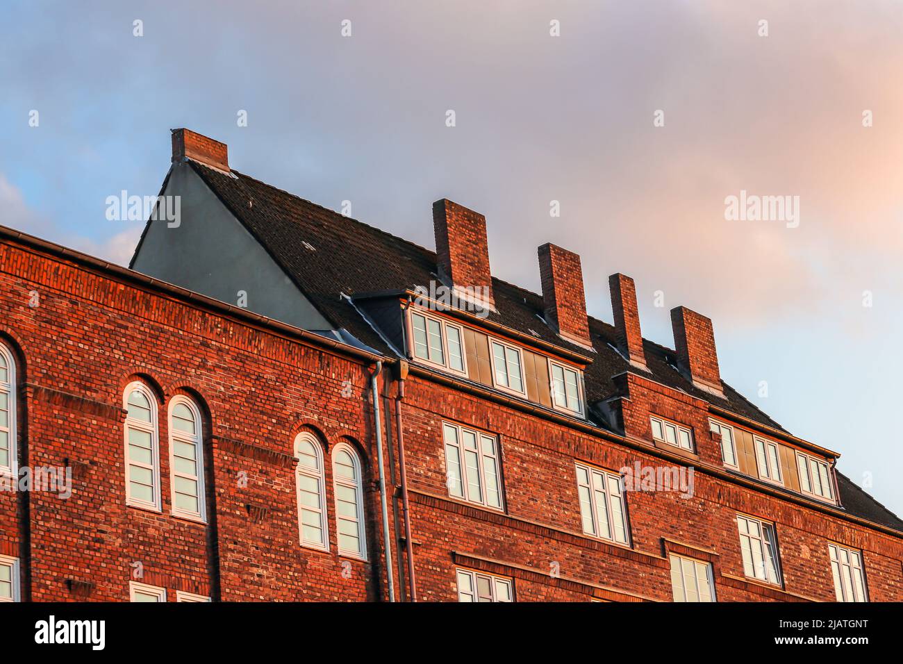 red brick apartment buildings with wide chimneys Stock Photo