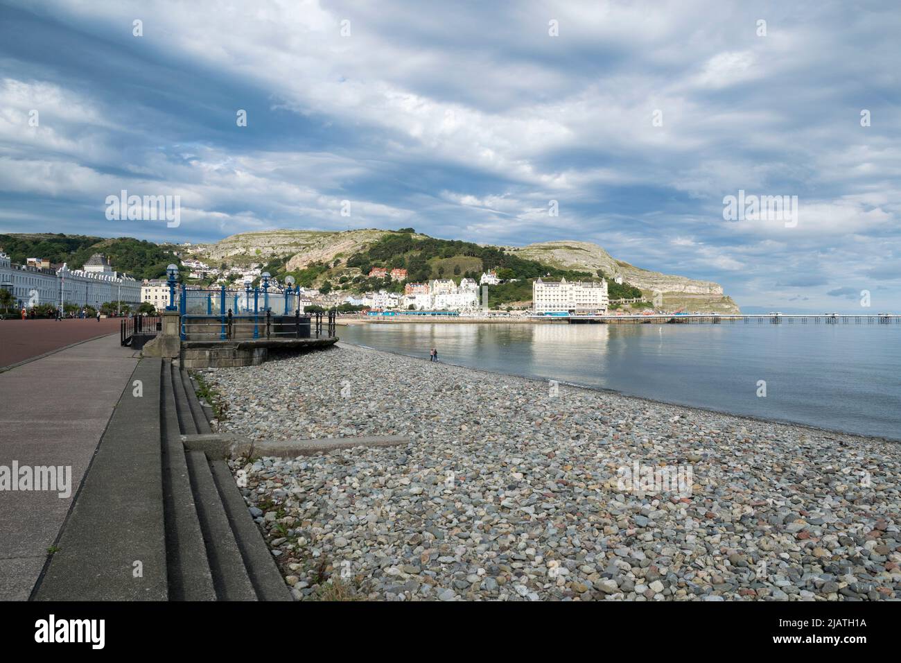 Llandudno promenade on the North Wales coast with the new ferris wheel, Grand hotel and the pier in the distance Stock Photo