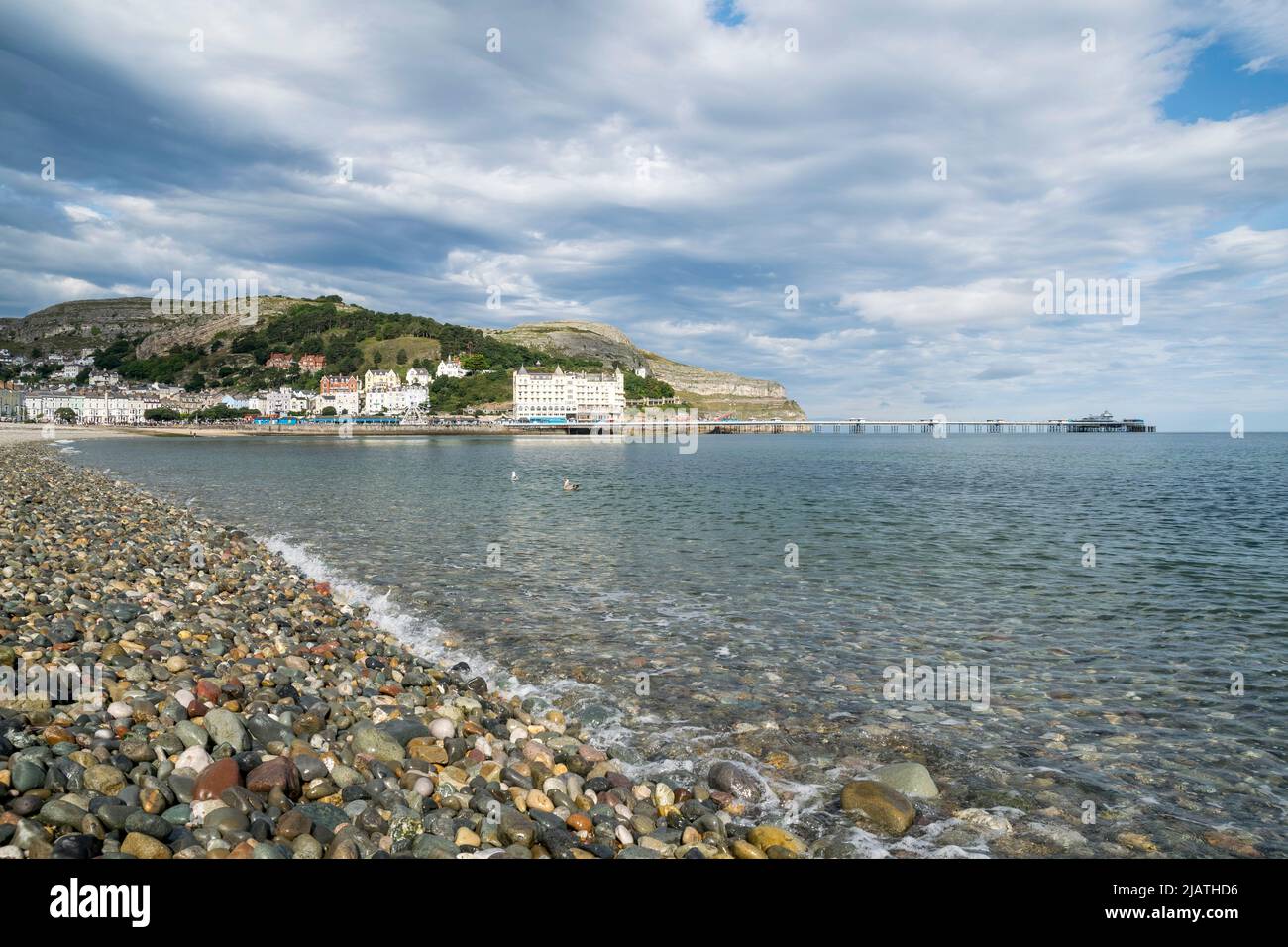 Llandudno promenade on the North Wales coast with the new ferris wheel and the pier in the distance Stock Photo