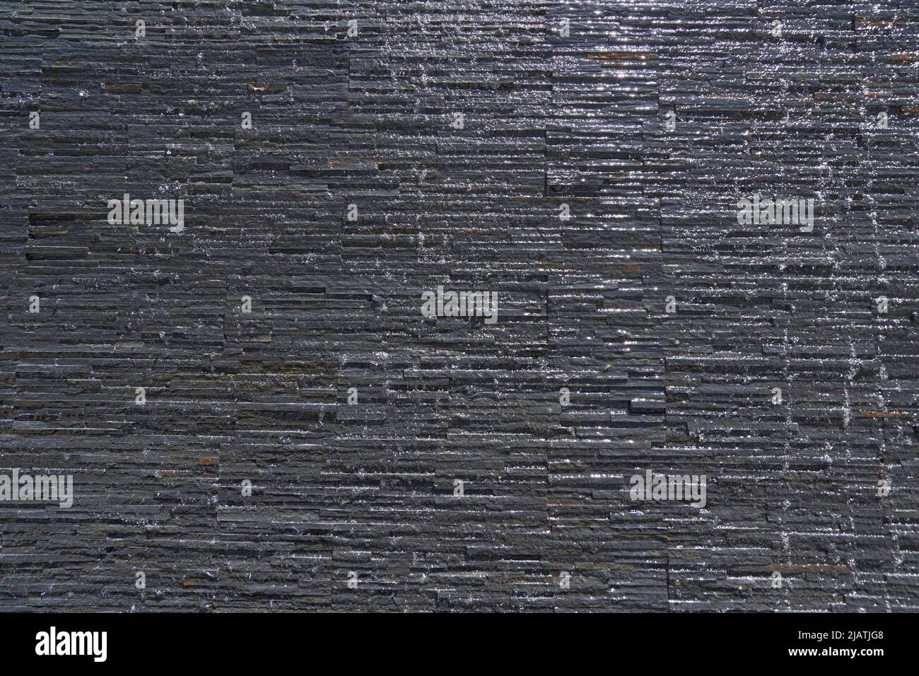 Flowing water on a stone wall Stock Photo