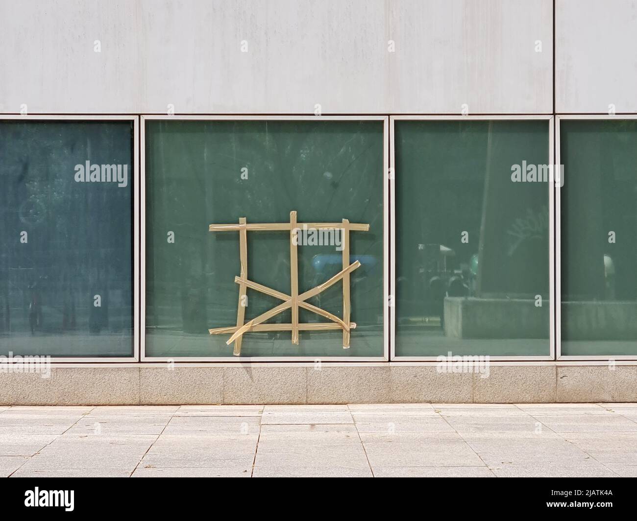 Broken window glass covered with duct tape Stock Photo Alamy