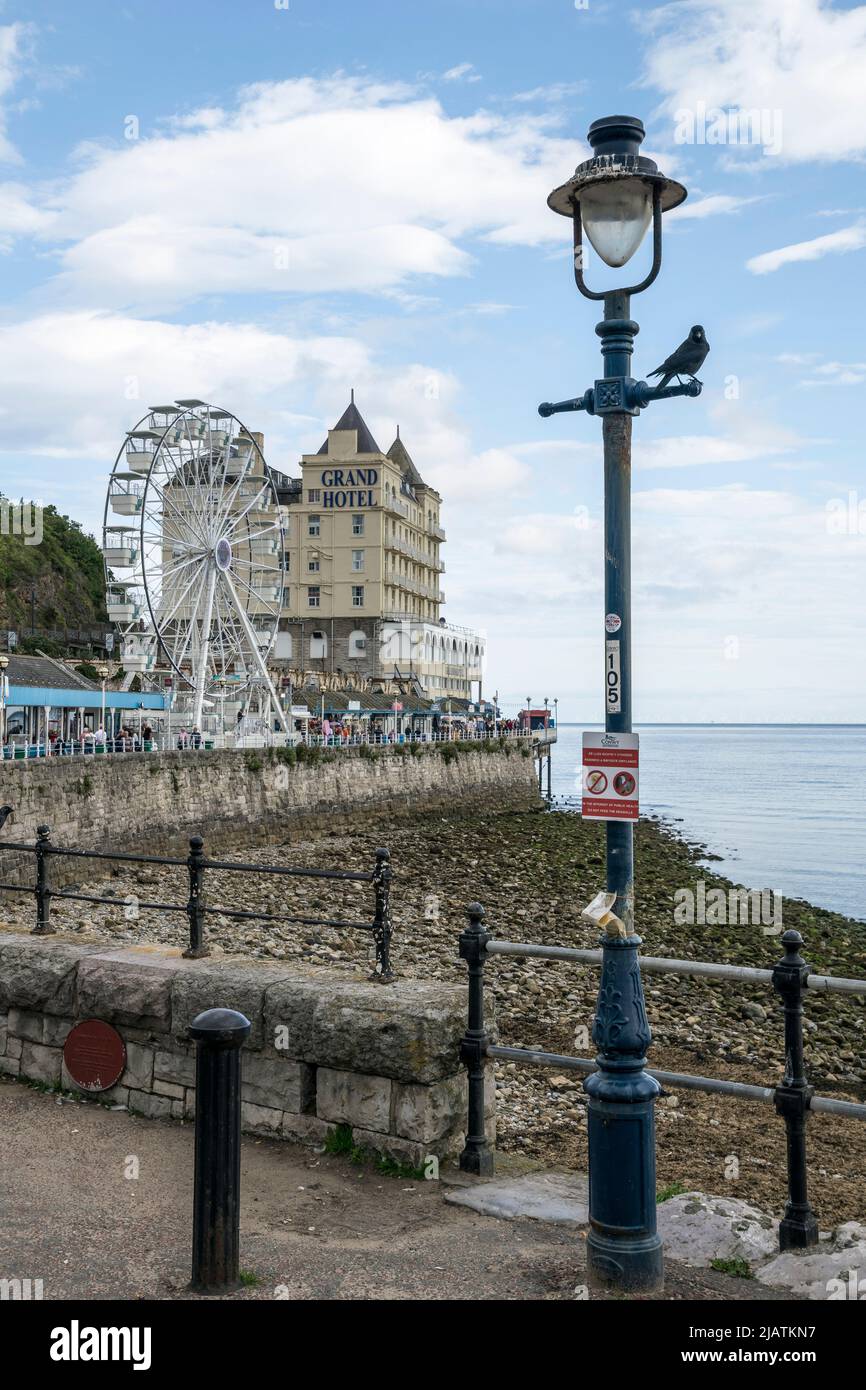 Llandudno promenade on the North Wales coast with the new ferris wheel and the Grand Hotel in the background Stock Photo
