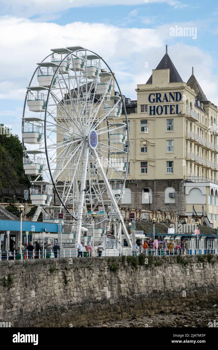 Llandudno promenade on the North Wales coast with the new ferris wheel and the Grand Hotel in the background Stock Photo