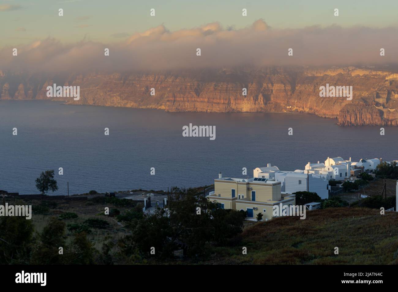 Sundown casts its golden light over Santorini's caldera Stock Photo
