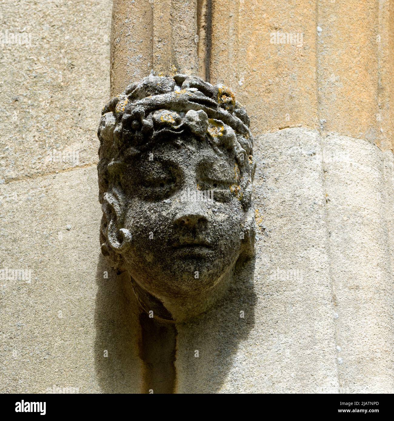 A carved head on the south face of St. Peter ad Vincula Church, Hampton Lucy, Warwickshire, England, UK Stock Photo