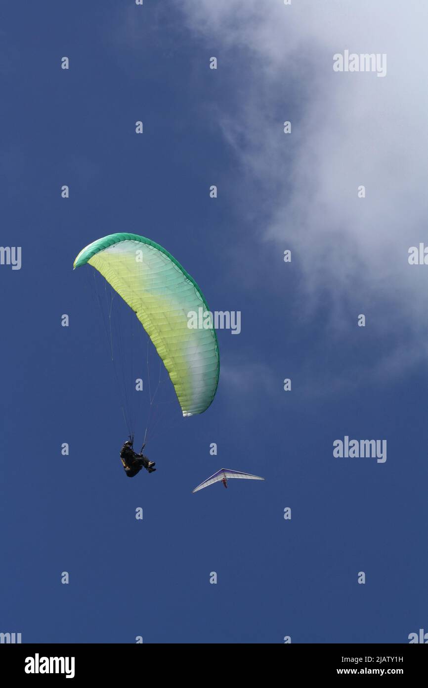 Hang-glider and paraglider in the blue sky Stock Photo