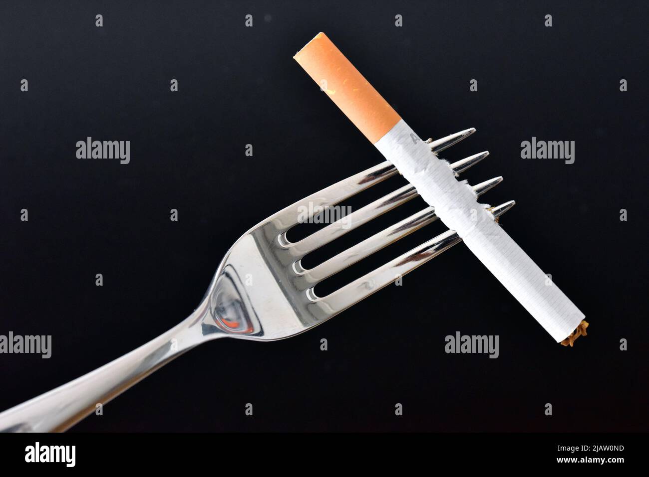 dinner fork with cigarette Stock Photo