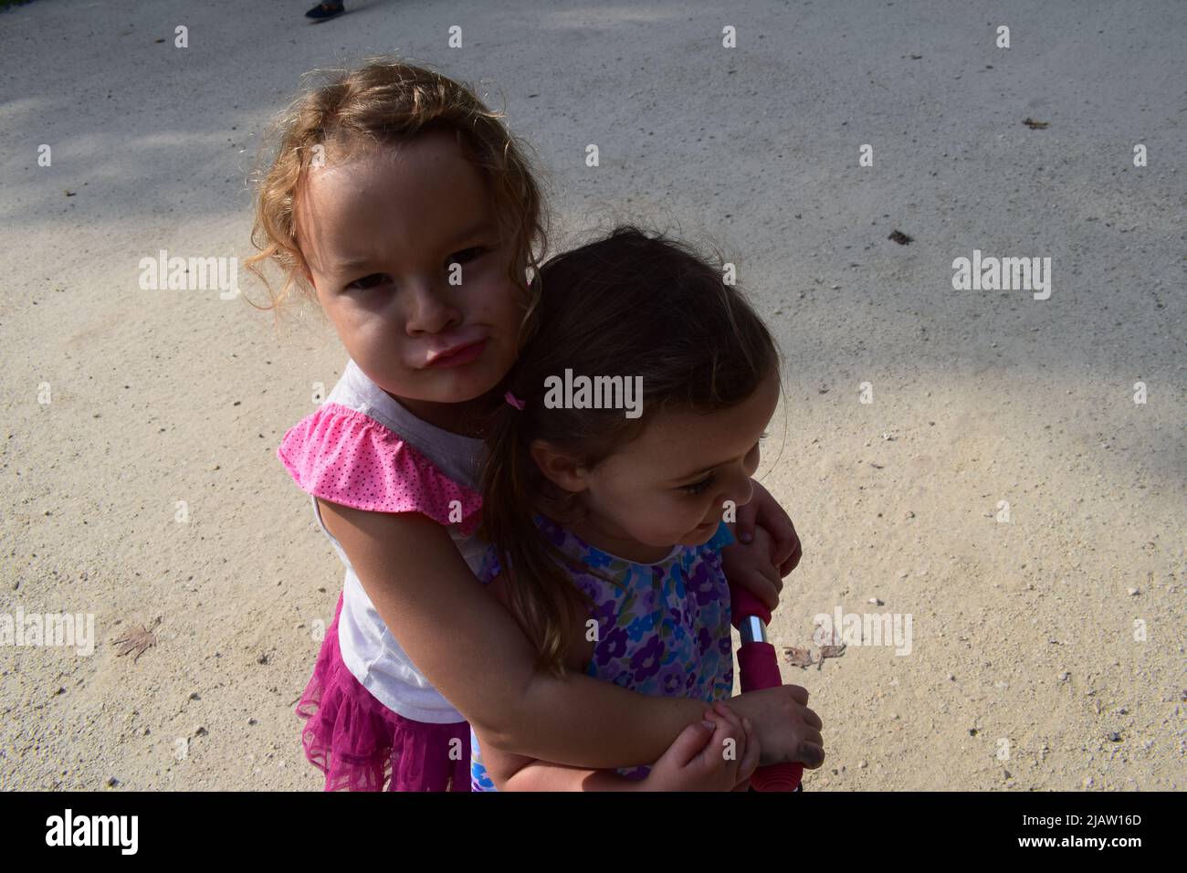 Children playing, hugging, sisters, love, best friends, family, outdoors Stock Photo Alamy