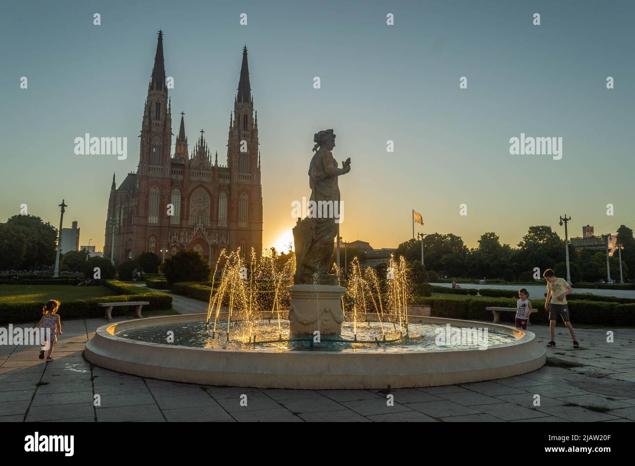 Square at sunset with children playing Stock Photo