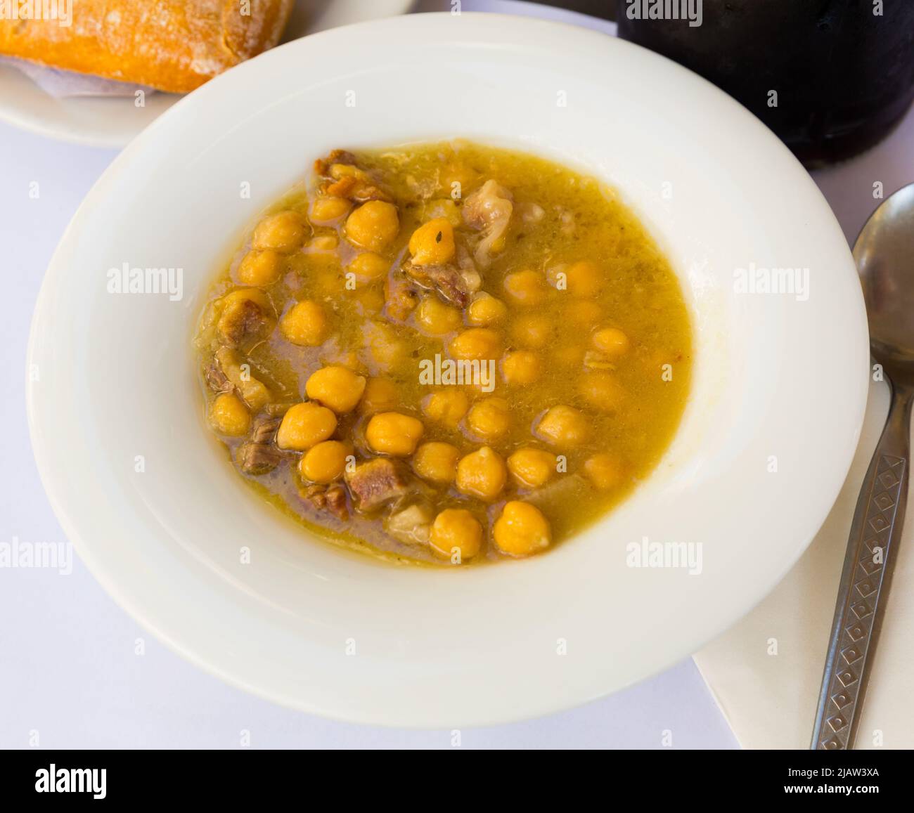 Stewed chickpeas with Iberian bacon Stock Photo