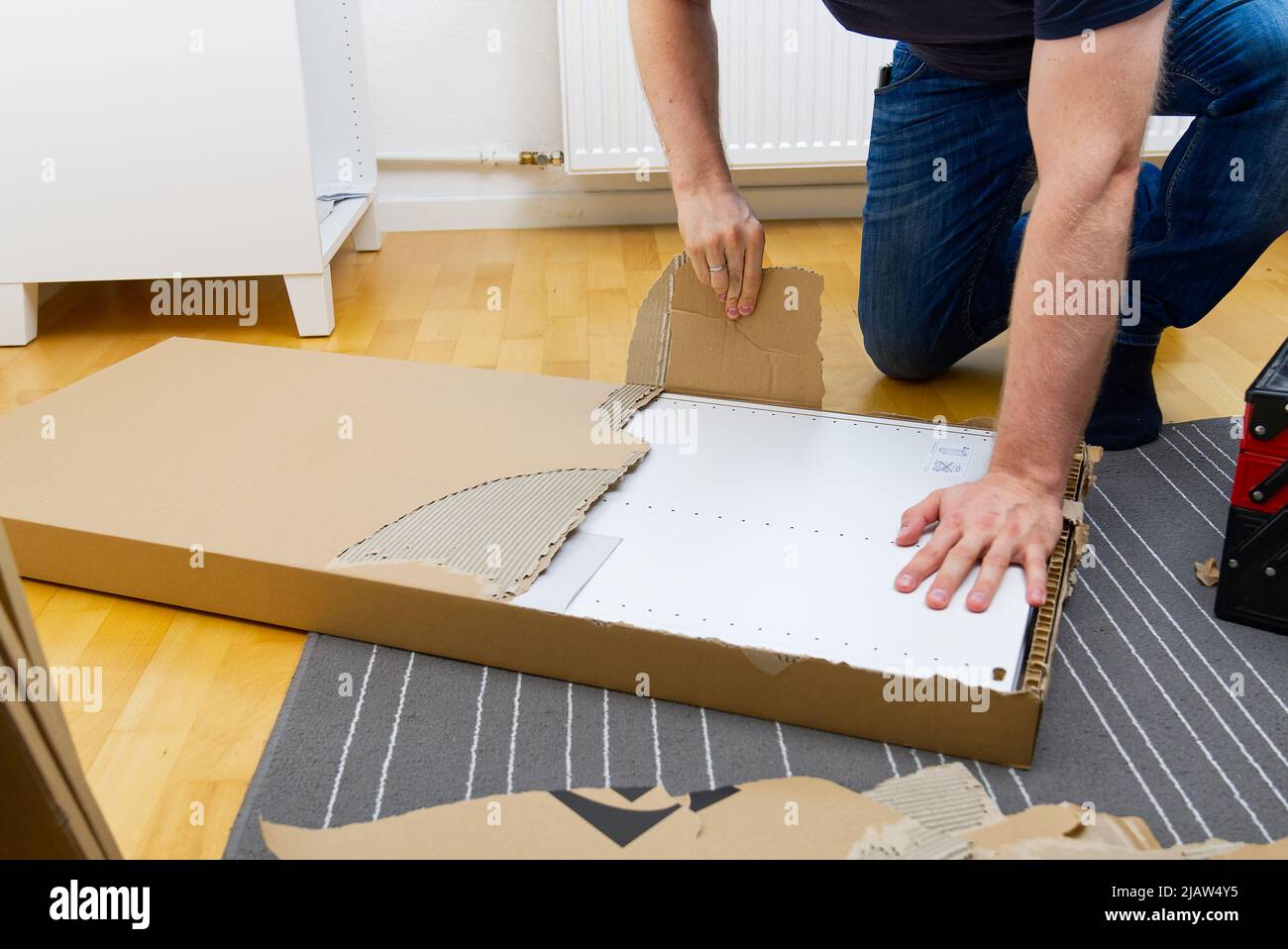 Professional Furniture Assembly Worker Assembles Shelf. Furniture