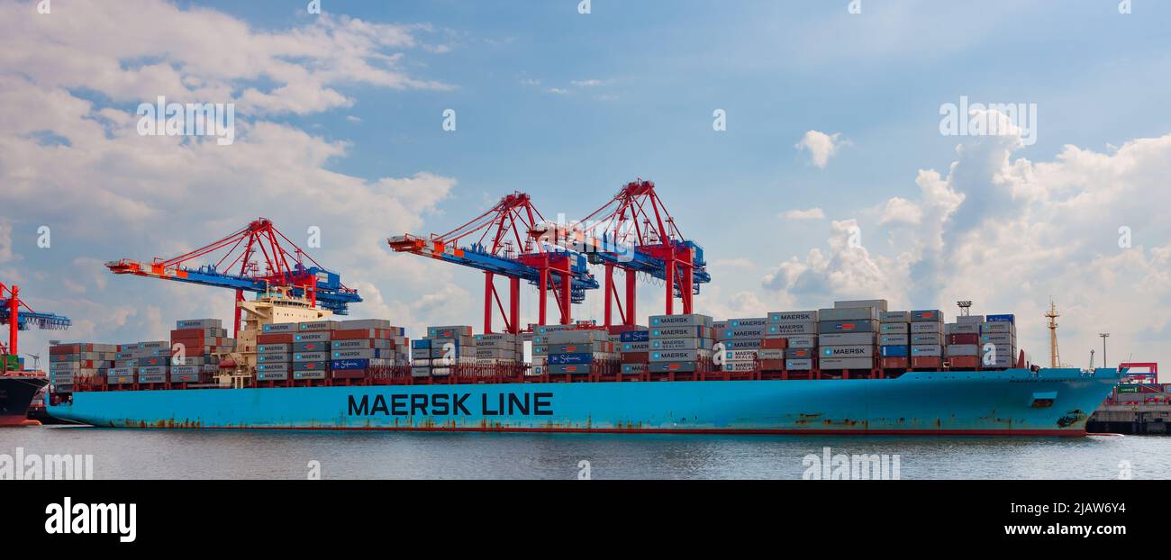 Hamburg, Germany - July 12, 2011 : Heavily laden Maersk Line cargo container ship docked on south shore of Elbe River. Stock Photo