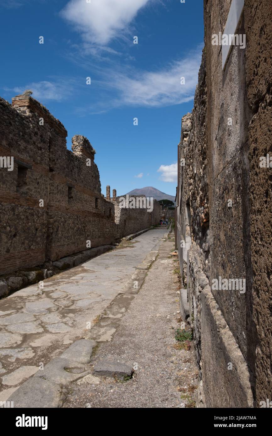 Street with walls of ruined houses in Pompeii, Italy Stock Photo