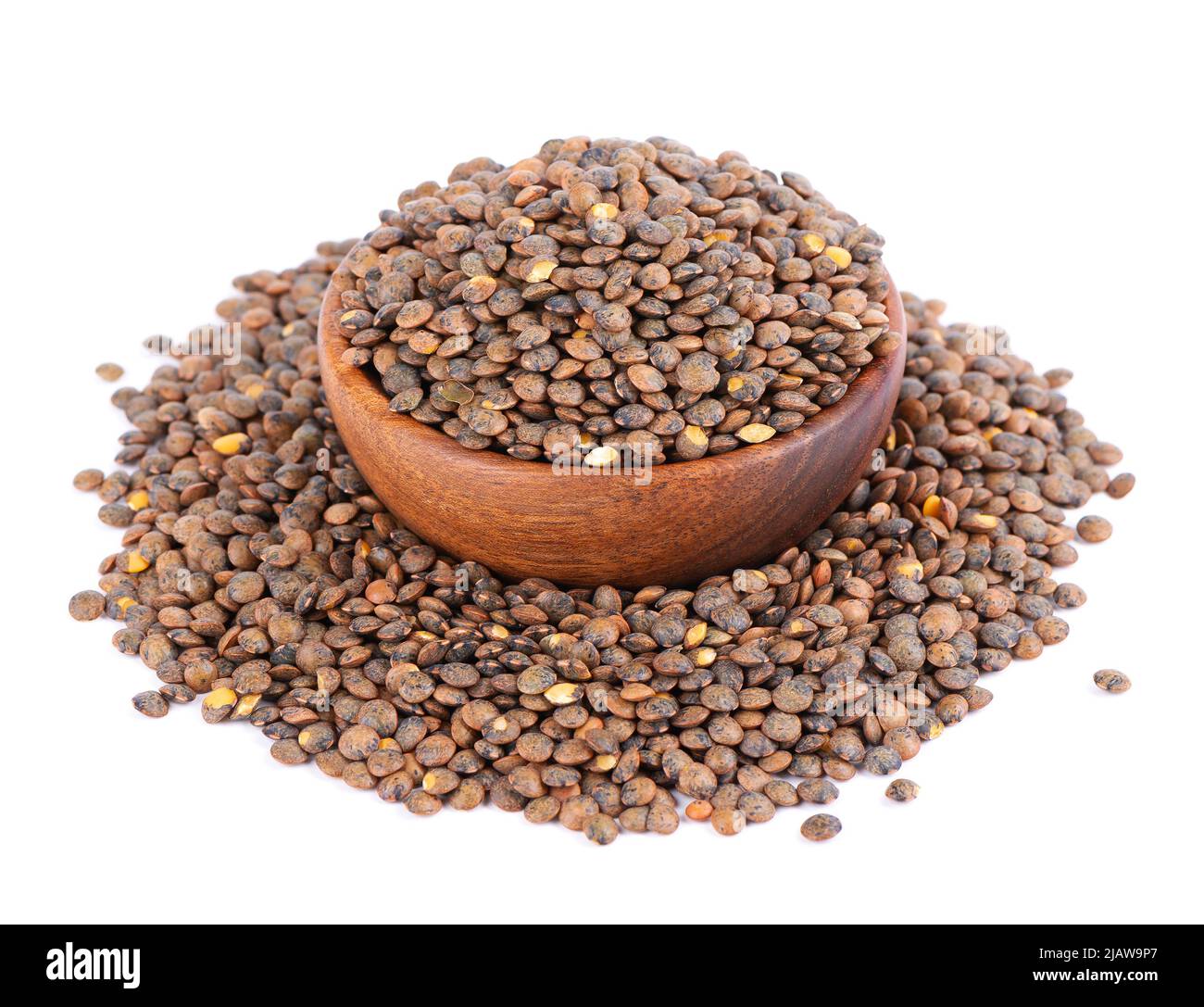 French lentils in wooden bowl, isolated on white background. Dry puy lentil grains pile Stock Photo