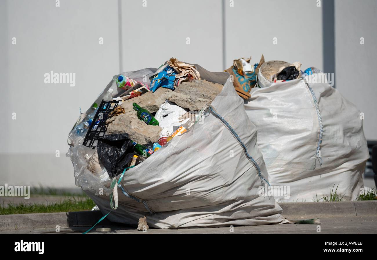 Legionowo, Poland - April 28, 2022: Big garbage bags and construction waste.  Big bags for waste standing on the sidewalk of a renovated building Stock  Photo - Alamy