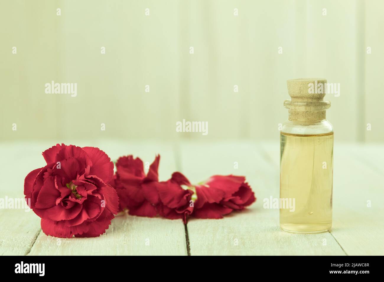 A bottle of aromatic oil made from fresh flower petals. Essential oil