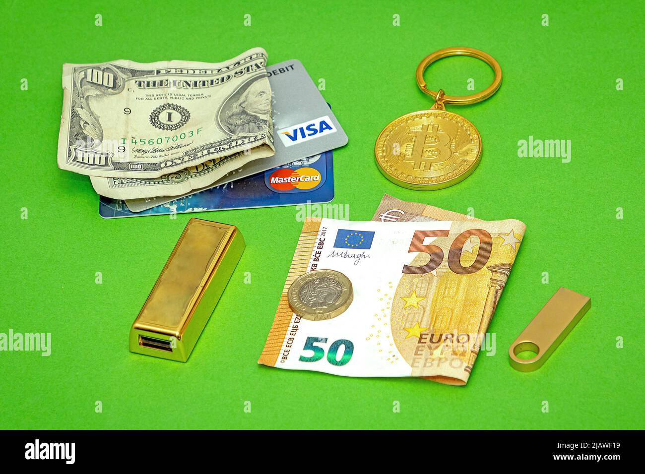 London, United Kingdom - May 27, 2022: Gold bitcoin crypto currency with  gold bar dollar and Euro paper bills and credit cards and coins as way of  pa Stock Photo - Alamy