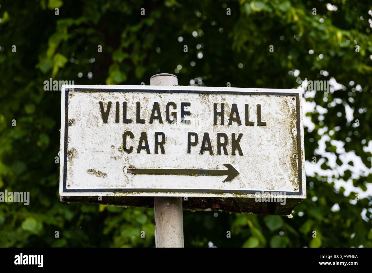 weathered Village Hall car park sign on white.Offord Cluny, Cambridgeshire, England Stock Photo